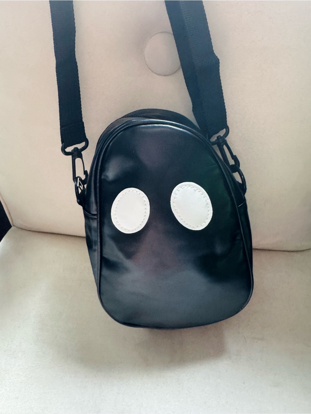 Black Crossbody Sling Bag with White Ghost Eyes Accent - Unisex